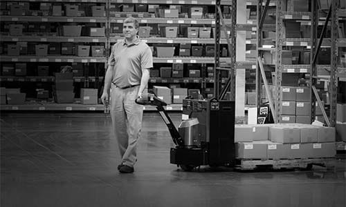 Warehouse worker hauls product using the LRW35 pallet jack