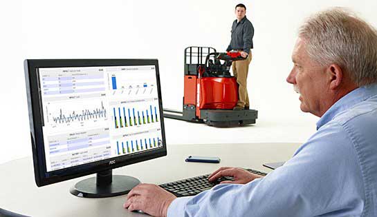 Warehouse manager reviews reports from iWAREHOUSE warehouse optimization consulting software on desktop